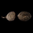 5th century B.C. With round-section hoop and scaphoid plaque, incuse advancing lion in profile on a baseline. 16.12 grams, 30.64 mm overall, 19.55 x 2...