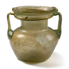 Roman Pale Green Glass Twin-Handled Jar. 4th century A.D.