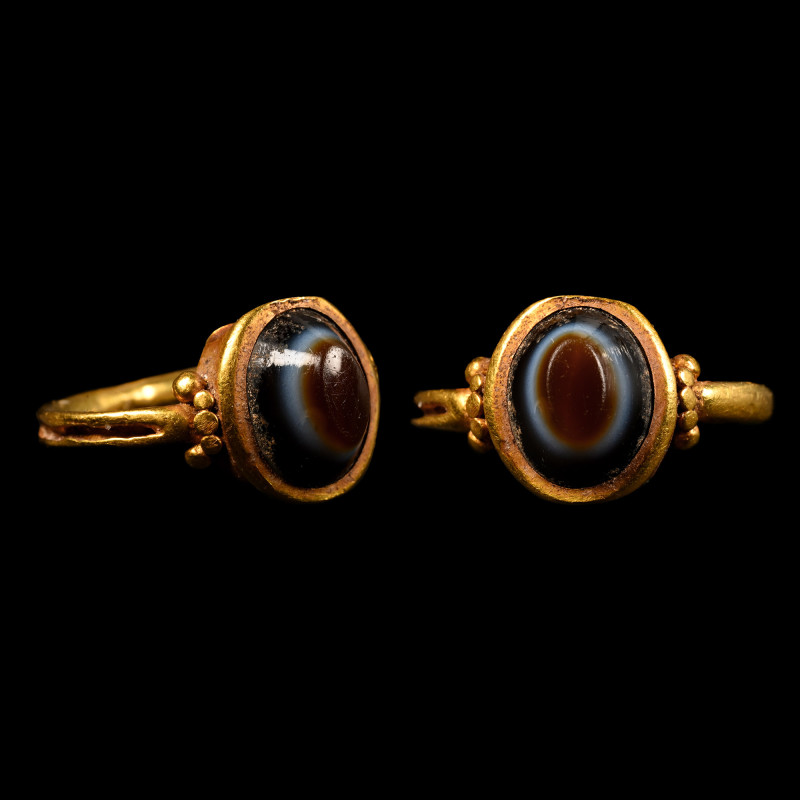 Roman Gold Ring with Eye Cabochon. 3rd-4th century A.D. Round-section hoop with ...