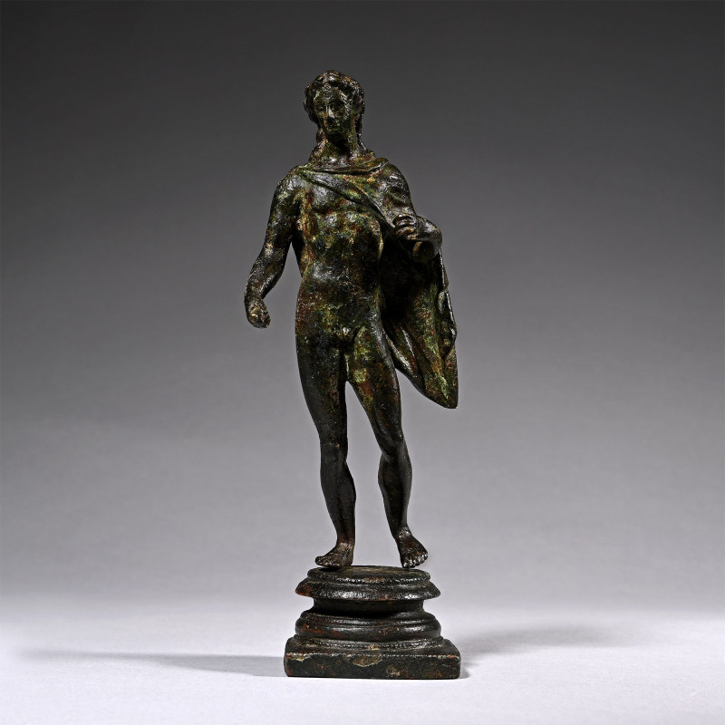 Roman Bronze Figure of Apollo. Circa 1st century A.D. Standing nude with a chlam...