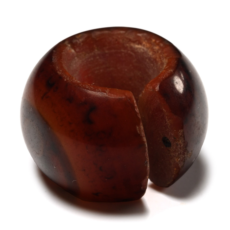 Egyptian Red Jasper Hair Ring. New Kingdom, 1550-1070 B.C. Circular with a semi-...