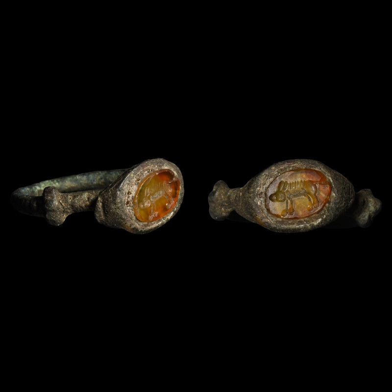 Roman Bronze Ring with Boar Gemstone. 3rd-4th century A.D. Comprising a round-se...