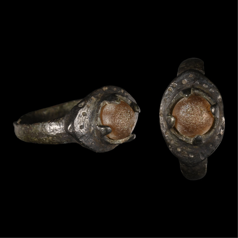 Viking Age Bronze Ring with Cabochon. 9th-12th century A.D. Comprising a slender...