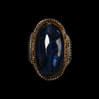 Large Silver-Coloured Metal Ring with Blue Glass Cabochon. 20th century A.D.