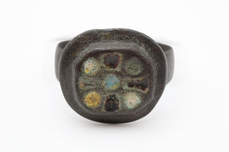 A bronze ring with enamelled plate bezel ,brown patina; 5.54 grams, 19.62 mm max...