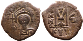 Maurice Tiberius (582-602) Follis. Obverse: Helmeted and cuirassed bust facing, holding globus cruciger and shield., Reverse: Large M above cross, ANN...