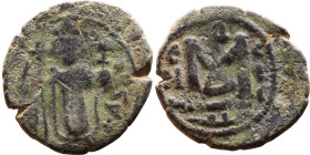al-Malik ibn Marwan (687-705), Byzantine style folis Obverse: Imperial figure holding globe and cross Reverse: M and inscription