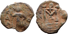 al-Malik ibn Marwan (687-705), Byzantine style folis Obverse: Imperial figure holding globe and cross Reverse: M and inscription