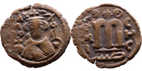 al-Malik ibn Marwan (687-705), Byzantine style folis Obverse: Imperial figure holding globe and cross Reverse: M and inscription