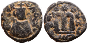 al-Malik ibn Marwan (687-705), Byzantine style folis Obverse: Imperial figure holding globe and cross Reverse: M and inscription