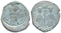 Constantine X Ducas and Eudocia AD 1059-1067. Constantinople Follis Æ (30mm, 11.8 g). +EMMANOVHΛ; Christ standing facing on footstool, wearing nimbus ...