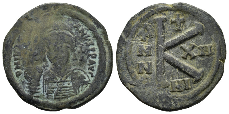JUSTINIAN I, (527-565 AD). Ae. Half Follis. Nicomedia 

Obv: Helmeted, pearl-dia...