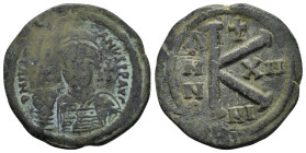 JUSTINIAN I, (527-565 AD). Ae. Half Follis. Nicomedia 

Obv: Helmeted, pearl-diademed and cuirassed bust facing, holding globus cruciger and shield wi...