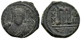 PHOCAS. (602-610 AD). Ae. Follis. Antioch 

Obv: Crowned facing bust, wearing consular robes and holding mappa and eagle sceptre 
Rev: Large m; cross ...