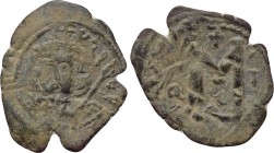 TIBERIUS III APSIMAR (698-705). Follis. Constantinople. 

Obv: Crowned and cuirassed facing bust, holding shield and spear.
Rev: Large M between A/...
