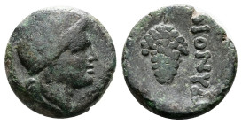 Moesia, Dionysopolis. 2nd Century BC. Bronze (16 mm, 4,10g.). Head of Dionysos to right, wreathed with ivy. Rev. Bunch of grapes, ΔΙΟNY to right. Tach...
