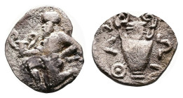 Island off Thrace, Thasos, circa 412-404 BC. Silver Trihemiobol ( 10 mm, 0.50 g.). Bald satyr kneeling left, holding kantharos in his right hand and r...