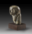 Shabti of Petamenophis, royal scribe and chief lector priest. Serpentine, H 8cm. Late Period, 26th dynasty,ca. 664 - 610 BC. Mummy-shaped with a tripa...