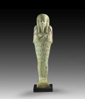 Shabti of Nefer-ib-Re-sa-Neith. Turquoise faience, H 19.4cm. Late Period, 26th dynasty, reign of Amasis, about 570 - 626 BC. Mummy-shaped with a back ...