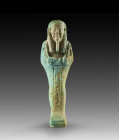 Shabti of Hor-em-achbit. Turquoise faience, H 13.3cm. Late Period, 30th dynasty - Ptolemaic Period, about 359 - 30 BC. Mummy-shaped with a back pillar...