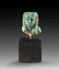 Shabti head of Isis-Nofret, wife of Ramses II. Turquoise faience, details in black paint, H 3,2cm. New Kingdom, 19th dynasty, ca. 1279 - 1213 BC. Head...