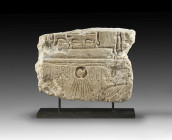 Talatat made of limestone, W 26cm, H 19.2cm, D 5cm. In the center the sun disk (the god Aton), from which rays emanate, that end in the small hands. T...
