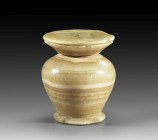 Kohl pot in fine banded alabaster complete with disc lid, part of the original contents remaining. The form has a pronounced shoulder and splayed foot...