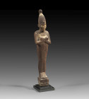 Osiris. Third Intermediate Period, 25th dynasty, ca. 700 BC. H 27,8cm. Wood. Mummy-shaped statuette with crossed arms on a base. The eyes inlaid in bo...