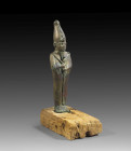 Statuette of a bronze Osiris standing on it's original base , H 21cm (with base). Late Period, 26th Dynasty, 7th century BC. Green and auburn patina, ...