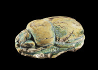 The Groppi Scarab. New Kingdom, 18th dynasty. Glazed terracotta, L 10.5cm H 3.8cm. The large scarab has sixteen lines of inscription on the bottom, wh...