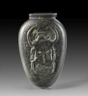 Heart scarab of Bakchons. Grey green schist. L 8.5cm. New Kingdom, 19th - 20th dynasty, 1292 - 1070 BC. Large scarab in raised relief on the front. Ab...