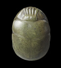 A finely carved greenish schist heart scarab with hieroglyphic inscription 30B from the book of the Death.The owners name was Ast. New Kingdom 19/20th...