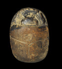 A finely carved steatite heart scarab with painted hieroglyphic inscription 30B (short form) from the book of the Death. The owners name was Djedchons...