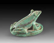 Frog amulet of blue-greenish faience, L 2.8cm, W 2.2cm. Sitting frog, inscription on the underside: Bastet and the son of Bastet love you every day . ...