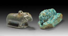 Two animal amulets: a) L 3cm, W 1.8cm, H 2cm. Made of faience with bluegreen glaze. With longitudinal drilling. Reclining lion on a rectangular base p...