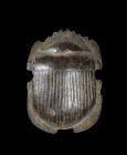 Scarab of black-brown ebony, L 2.1cm. Naturalistically modelled scarab without inscription. Late Period, about 500 BC. Tiny fragment missing, cracks o...