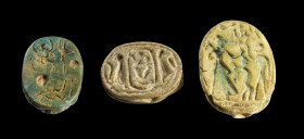 Collection of three scarabs: a) L 1.5cm. Made of green glazed steatite with a longitudinal hole. Inscription on the underside: the throne name of Seth...