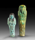 Two shabtis. a) Turquoise faience, details in black colour, H 6.7cm. 20th Dynasty, ca. 1185 - 1070 BC. Mummy-shaped with tripartite wig and ploughs in...