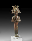 Bronze statuette of the standing Osiris, hollow cast, the eyes with two-couloured inlays, H 15.7cm. Late Period, 26th Dynasty, 7th century BC. Green a...