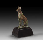 A bronze figure of a cat seated with erect ears representing the goddess Bastet, H 11.5cm (including the inlet pins). 22nd - 26th dynasty, 944 - 525 B...