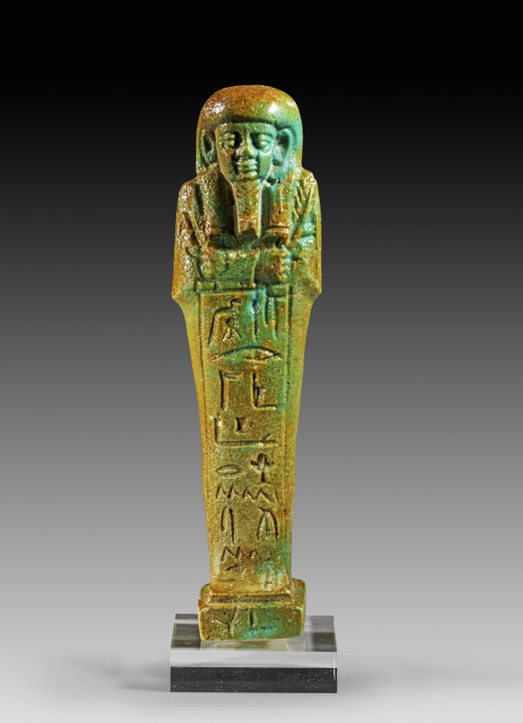 Ushabti of Padjhor-Mehen, faience, light blue glaze. Mummiform, with arms crosse...