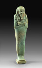 Ushabti made of turquoise faience in the name of Horiu. Late Period, 26th - 30th dynasty, 664 - 332 BC. H 13,8cm. On the back side pillar with hierogl...