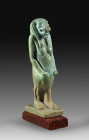 Amulet pendant of green faience in shape of Thoeris (H 5cm with plinth 5.5cm). Late Period, 6th - 2nd century BC. Intact, on wooden plinth. With copy ...