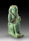 Amulet in shape of enthroned Isis who gives the baby Horus her breast on her lap. Lightgreen faience, H 3.3cm. Late Period, 4th - 3rd century BC. Crow...