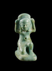 Amulet of god Shu, faience, light turquoise glaze, H 2.9cm. Despite the small size of the object the details of the face and the kilt are very well de...