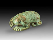 Naturalistic light green faience scarab with a finely detailed back und deeply carved underside. Loop on the underbelly, L 4.4cm, W 3.2cm. Late Period...