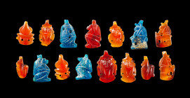Collection of carnelian and glass amulets, probably from a necklace. The four blue glass amulets depict the four sons of Horus. The carnelian amulets ...