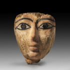 Wooden funerary mask with rests of stucco and black colour, L 18cm. Late Period, 26th - 31st dynasty, ca. 664 - 332 BC. At the backside adhesive resid...
