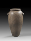 Brown-black greywacke vase. Elegant, elongated ovoid body with a flat base, narrow, horizontal lip, and horizontal, elongated eyelets. Early Dynastic ...