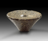 Club head from Predynastic Period. 4000 - 3400 BC. ø 10.2cm. Made of greenish and white speckled diorite. Conical shape with central hump on the wide ...